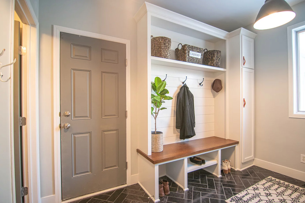 Inspiration for a mid-sized transitional slate floor and black floor laundry room remodel in Minneapolis with an utility sink, shaker cabinets, white cabinets, wood countertops, slate backsplash, a side-by-side washer/dryer and brown countertops