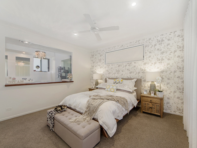 Design ideas for a large contemporary master bedroom in Gold Coast - Tweed with white walls, carpet and beige floor.