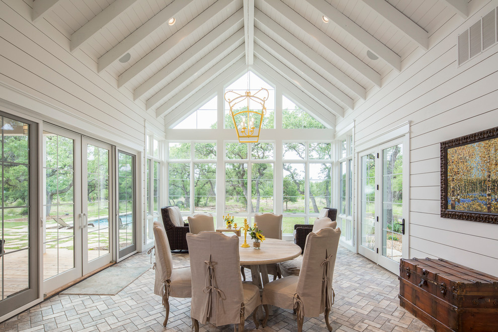 Country sunroom in Austin with a standard ceiling and grey floor.