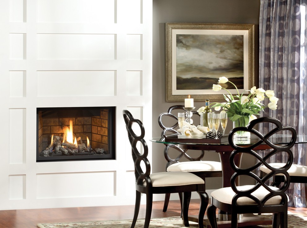 This is an example of a modern dining room in Denver with grey walls, a wood fireplace surround and a ribbon fireplace.