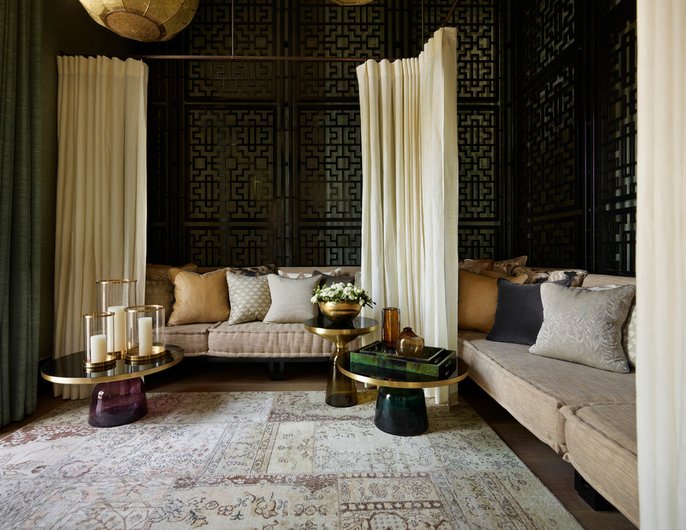Mediterranean formal living room in London with black walls and light hardwood floors.