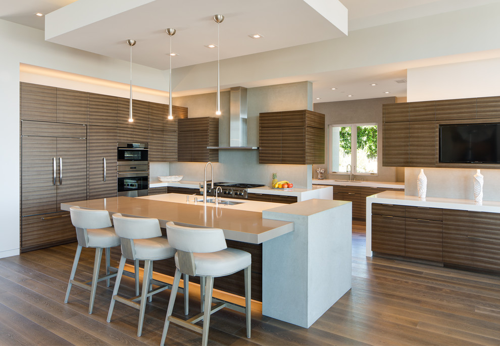 Photo of a contemporary l-shaped kitchen in San Diego with an undermount sink, flat-panel cabinets, brown cabinets, grey splashback, panelled appliances, dark hardwood floors, with island and brown floor.