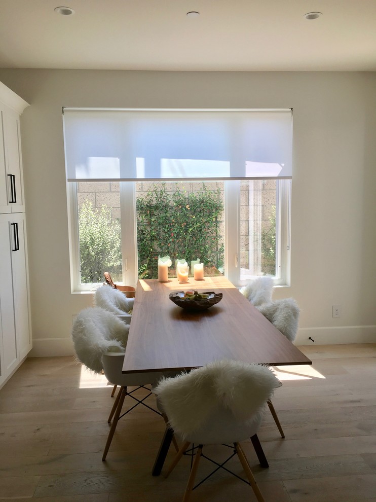 Dining room - mid-sized transitional medium tone wood floor and brown floor dining room idea in Orange County with beige walls and no fireplace