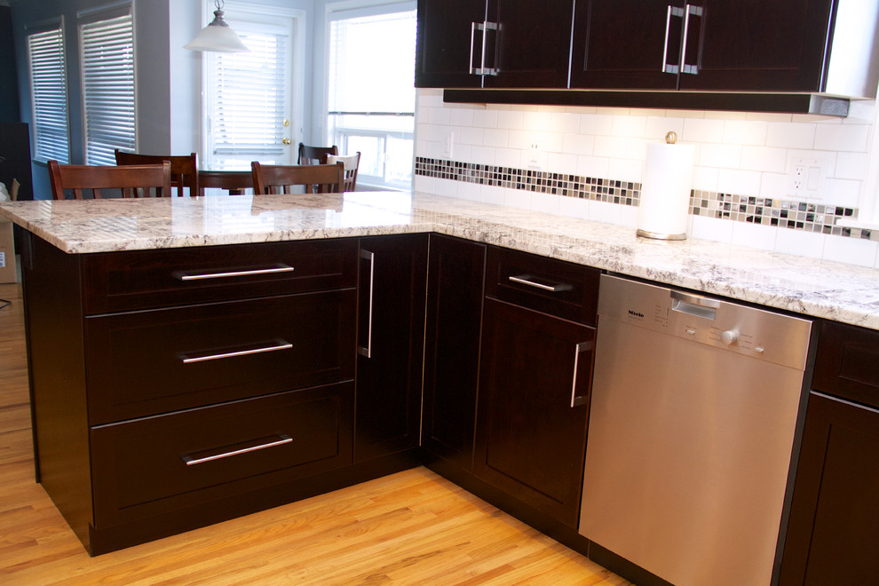 This is an example of a contemporary u-shaped eat-in kitchen in Vancouver with an undermount sink and shaker cabinets.