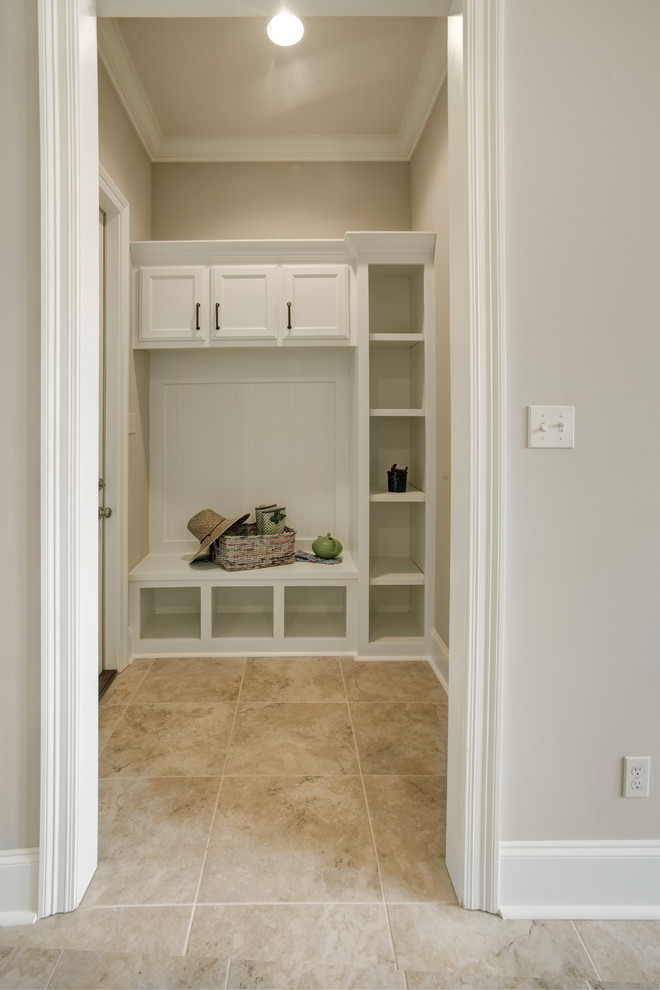 Inspiration for a mid-sized transitional mudroom in New Orleans with beige walls, ceramic floors and beige floor.