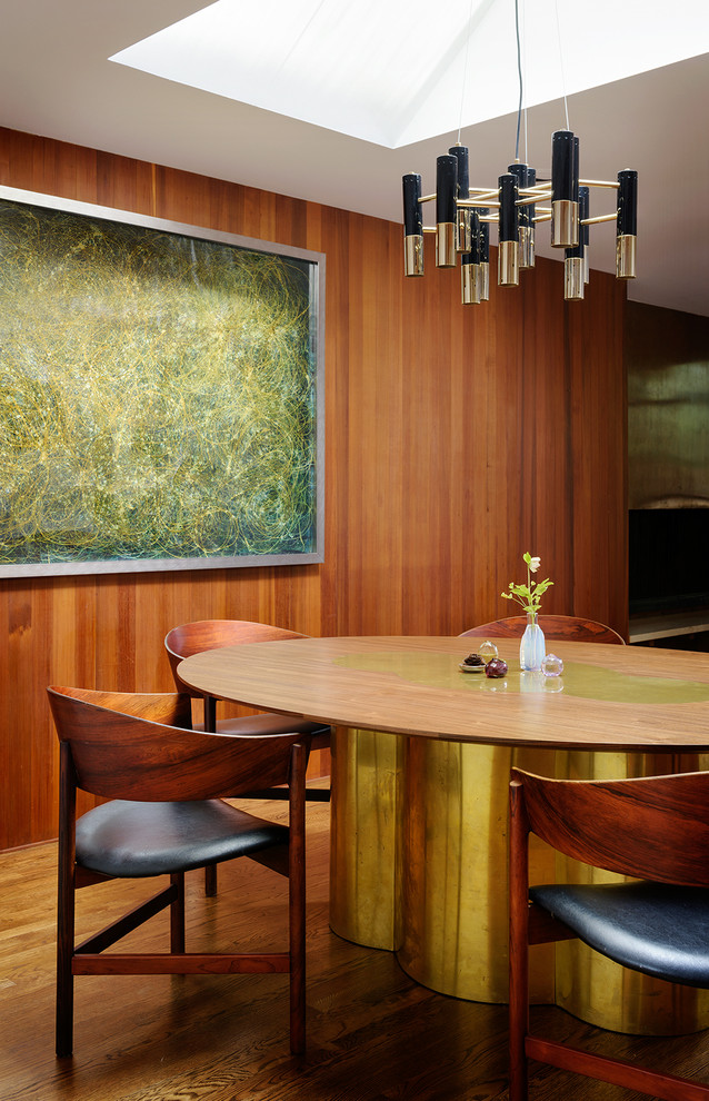 Design ideas for a midcentury dining room in Portland with medium hardwood floors.