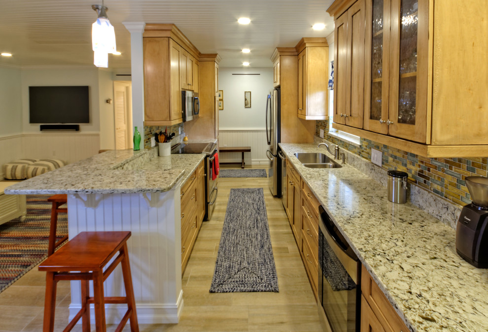 Mid-sized arts and crafts galley open plan kitchen in Miami with shaker cabinets, light wood cabinets, quartzite benchtops, multi-coloured splashback, mosaic tile splashback, stainless steel appliances, ceramic floors, a double-bowl sink and a peninsula.