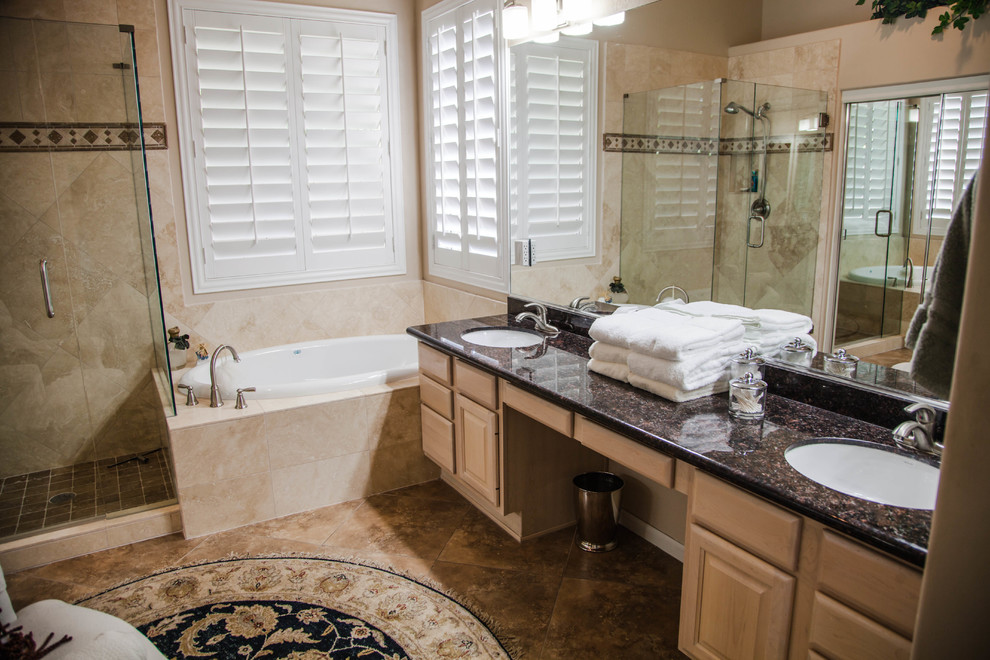 Example of a large transitional master ceramic tile drop-in bathtub design in Phoenix with raised-panel cabinets, light wood cabinets, beige walls, an undermount sink and granite countertops
