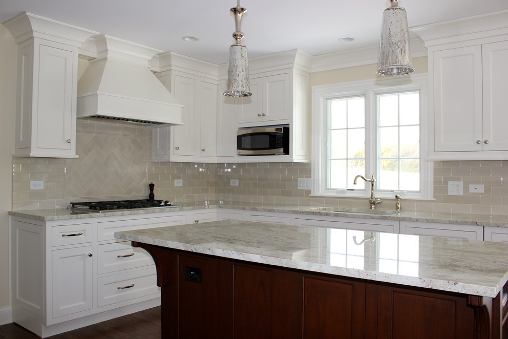 Example of a mid-sized transitional u-shaped dark wood floor and brown floor eat-in kitchen design in Chicago with beige cabinets, granite countertops, beige backsplash, ceramic backsplash, stainless steel appliances, beige walls, an undermount sink, recessed-panel cabinets, an island and beige countertops