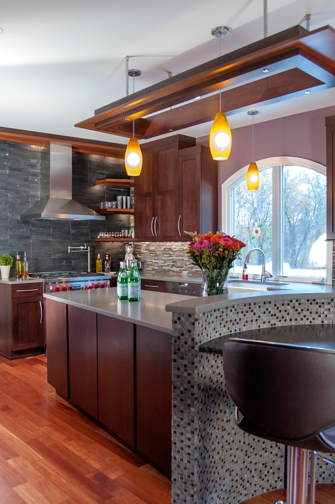 Mid-sized asian l-shaped eat-in kitchen in Philadelphia with a farmhouse sink, shaker cabinets, dark wood cabinets, quartz benchtops, multi-coloured splashback, stainless steel appliances, medium hardwood floors and with island.