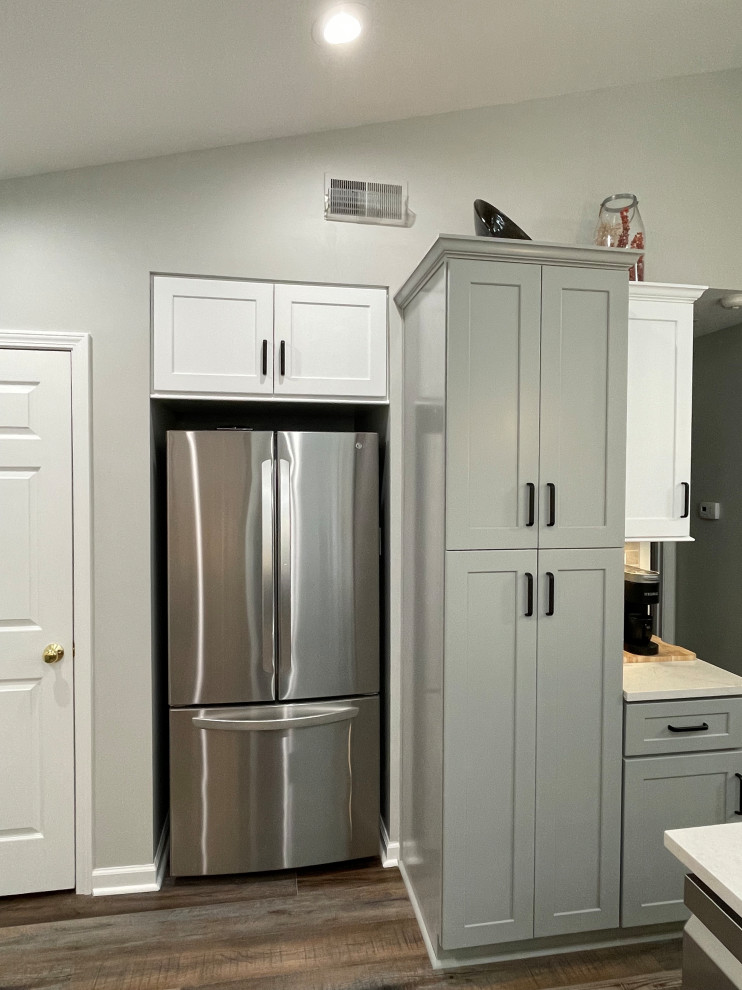 Example of a small transitional vinyl floor and brown floor kitchen pantry design with shaker cabinets, gray cabinets, quartz countertops, stainless steel appliances, no island and white countertops
