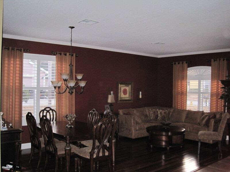 Photo of a mid-sized traditional open plan dining in Orlando with red walls and dark hardwood floors.