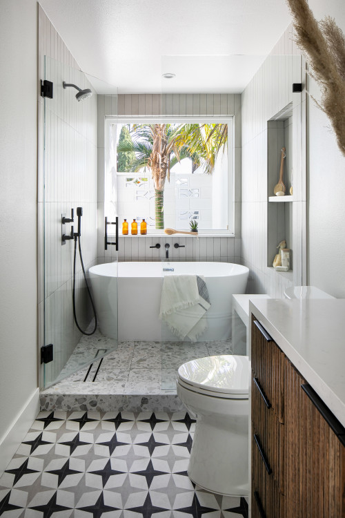 After raising this roman tub, we fit a mix of neutral patterns into this beautiful space for a tranquil midcentury primary suite designed by Kennedy Cole Interior Design.
Bathroom - small 1960s master gray tile and ceramic tile ceramic tile, multicolored floor and single-sink bathroom idea in Orange County with furniture-like cabinets, medium tone wood cabinets, a one-piece toilet, white walls, an undermount sink, quartz countertops, a hinged shower door, white countertops and a built-in vanity 