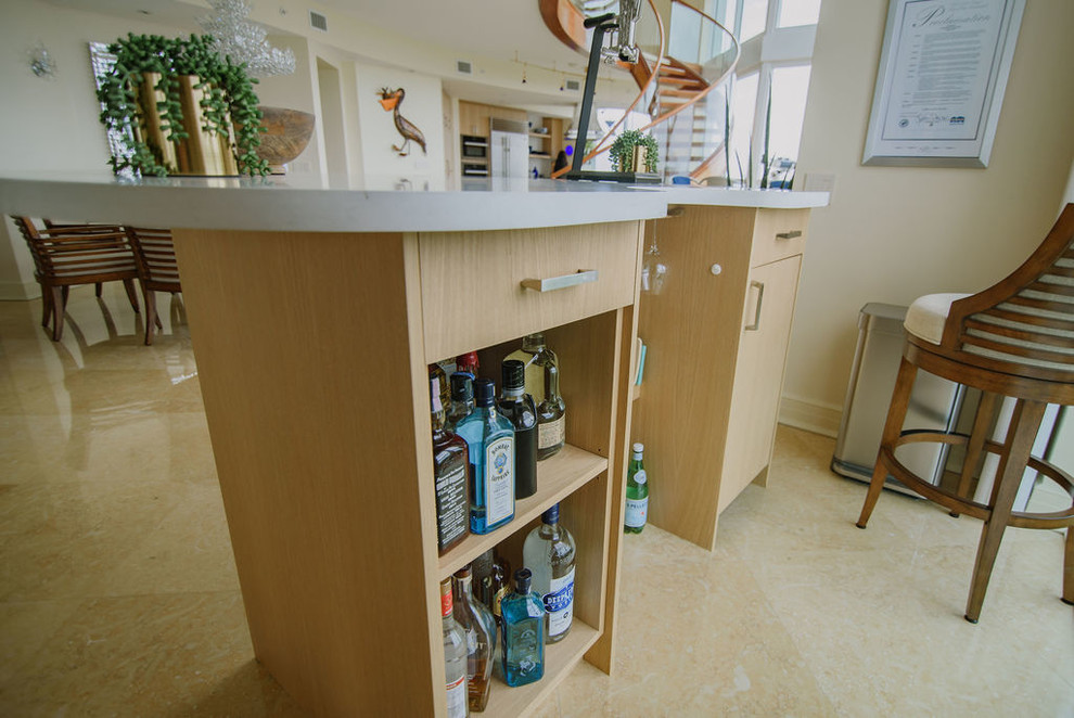 Inspiration for a mid-sized transitional u-shaped porcelain tile and beige floor open concept kitchen remodel in Miami with an undermount sink, flat-panel cabinets, light wood cabinets, quartz countertops, white backsplash, stainless steel appliances, an island and white countertops