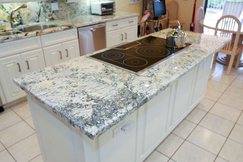 Example of a large transitional galley ceramic tile eat-in kitchen design in Miami with a double-bowl sink, raised-panel cabinets, white cabinets, granite countertops, multicolored backsplash, stone slab backsplash, stainless steel appliances and an island