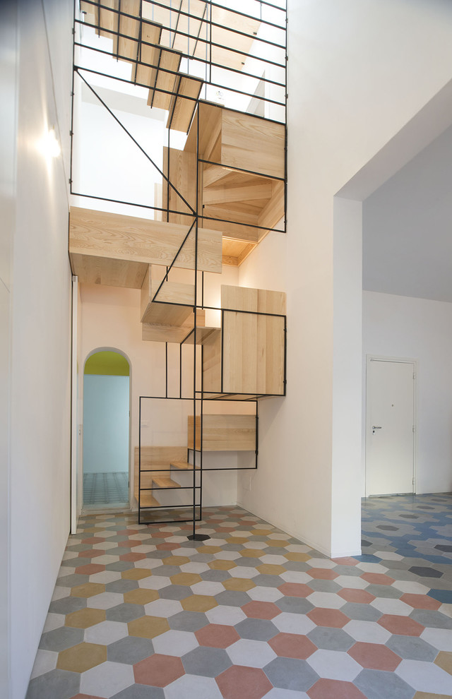 This is an example of a contemporary wood staircase in Milan with open risers.