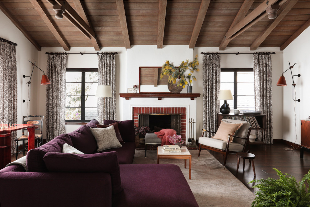 Inspiration for a large traditional living room in San Francisco with white walls, dark hardwood floors, a standard fireplace, a brick fireplace surround and a wall-mounted tv.