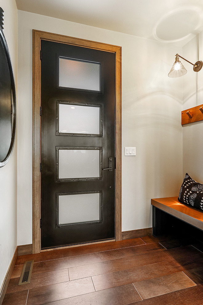 Example of a transitional medium tone wood floor and brown floor single front door design with gray walls
