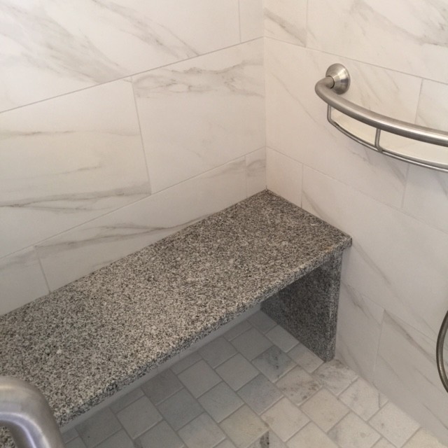 This is an example of a small arts and crafts master bathroom in Other with an undermount sink, shaker cabinets, white cabinets, granite benchtops, white tile, porcelain tile, grey walls and porcelain floors.