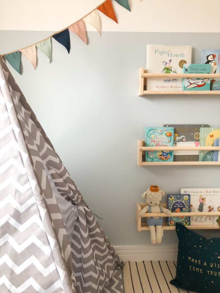 Design ideas for a small modern nursery for boys in Edinburgh with blue walls, carpet and beige floors.
