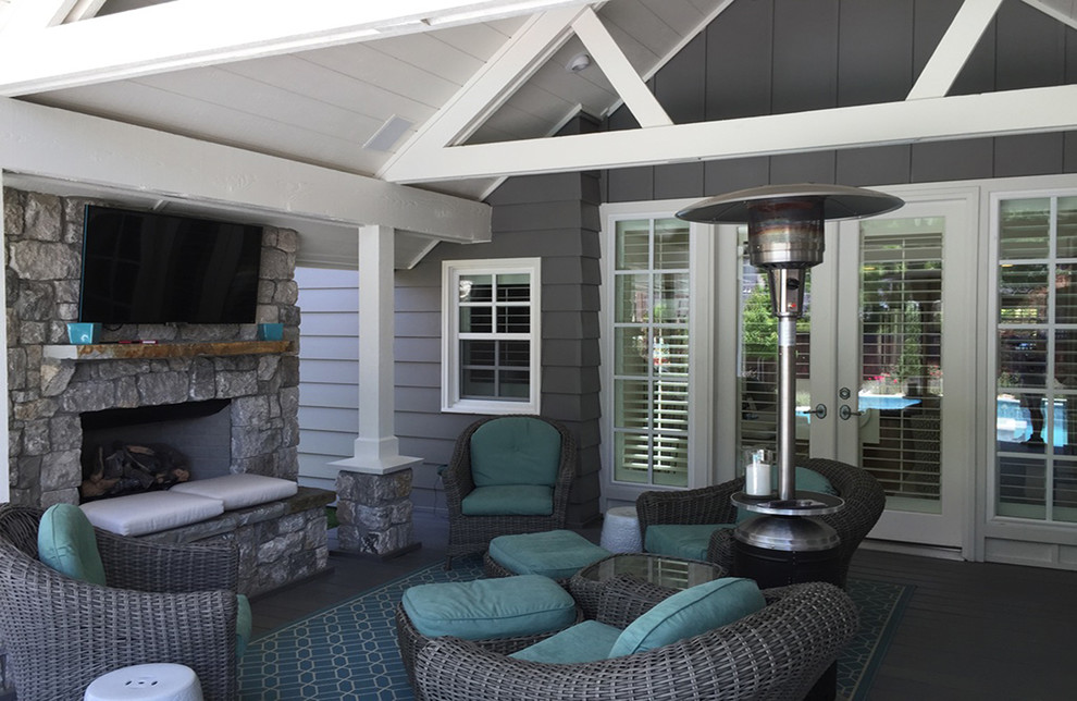 Inspiration for a large transitional backyard patio remodel with a fire pit, decking and a roof extension