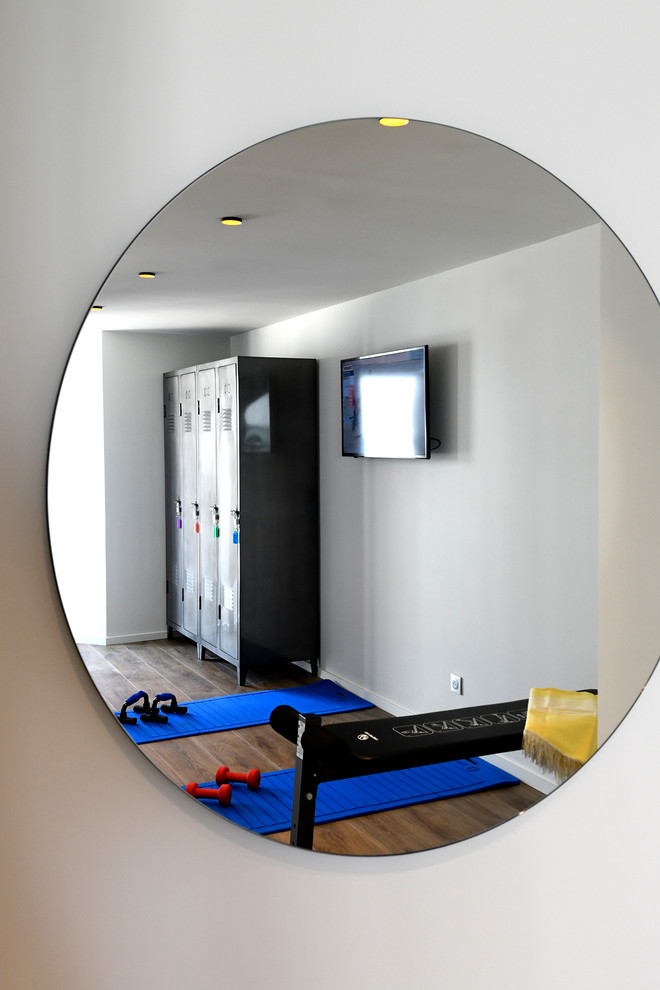 This is an example of a small mediterranean multipurpose gym in Marseille with grey walls.