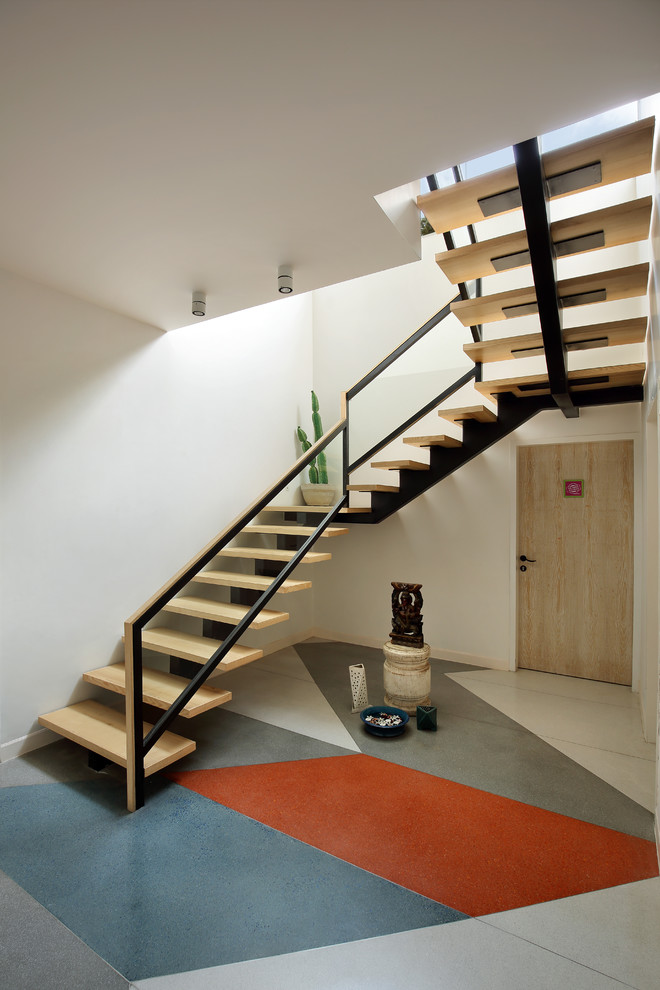 Inspiration for a contemporary wood u-shaped staircase in Ahmedabad with open risers.