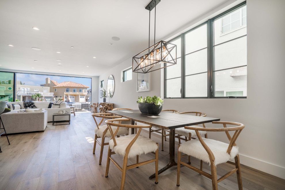 Inspiration for a contemporary open plan dining in Orange County with white walls, medium hardwood floors and brown floor.