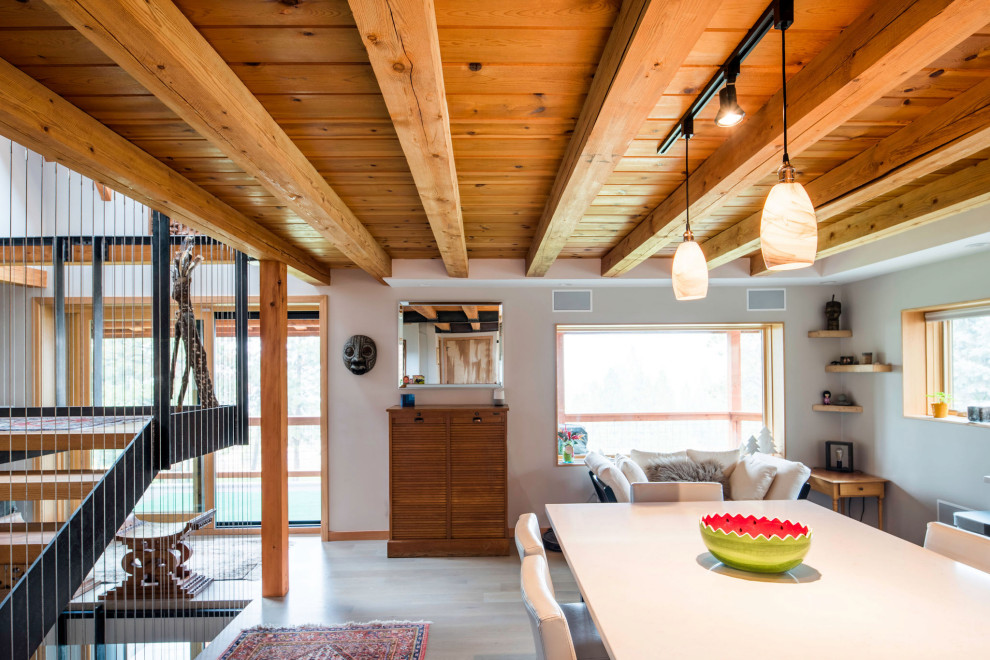 Mountain style galley exposed beam open concept kitchen photo with flat-panel cabinets, gray cabinets, wood countertops, an island and white countertops