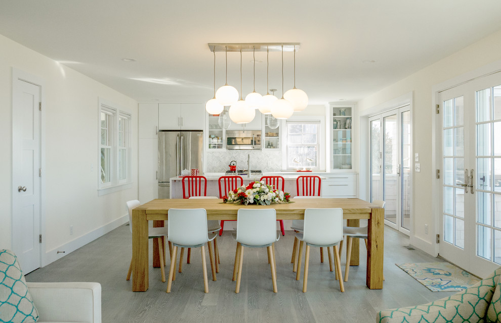 Design ideas for a mid-sized beach style kitchen/dining combo in Boston with white walls and medium hardwood floors.