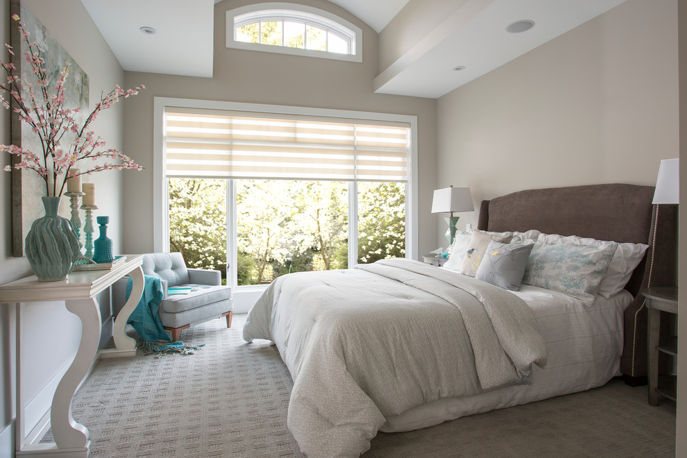 Inspiration for a large transitional master bedroom in Calgary with beige walls and carpet.