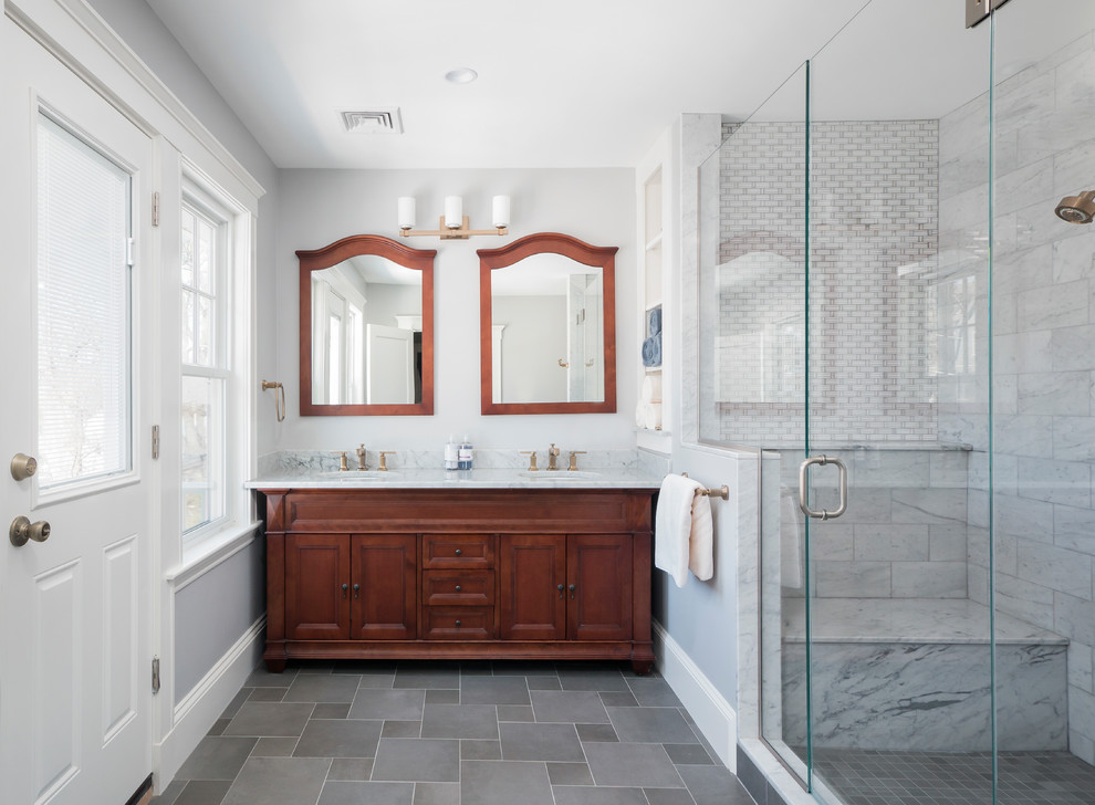 Inspiration for a mid-sized traditional master bathroom in Boston with medium wood cabinets, gray tile, marble, marble benchtops, grey walls, an undermount sink, grey floor, a hinged shower door and recessed-panel cabinets.