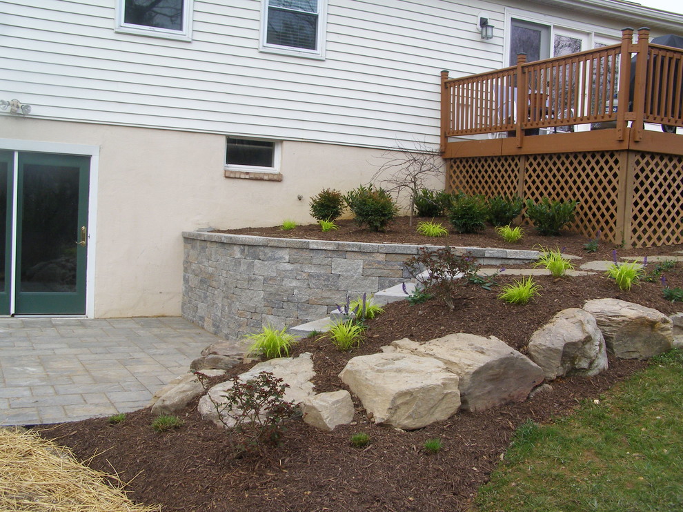 Design ideas for a mid-sized contemporary backyard patio in Baltimore with natural stone pavers and no cover.