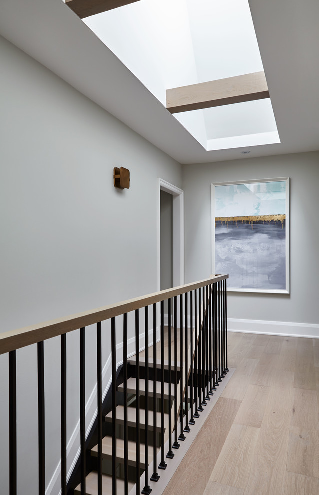 Design ideas for a transitional wood staircase in Toronto with open risers and mixed railing.