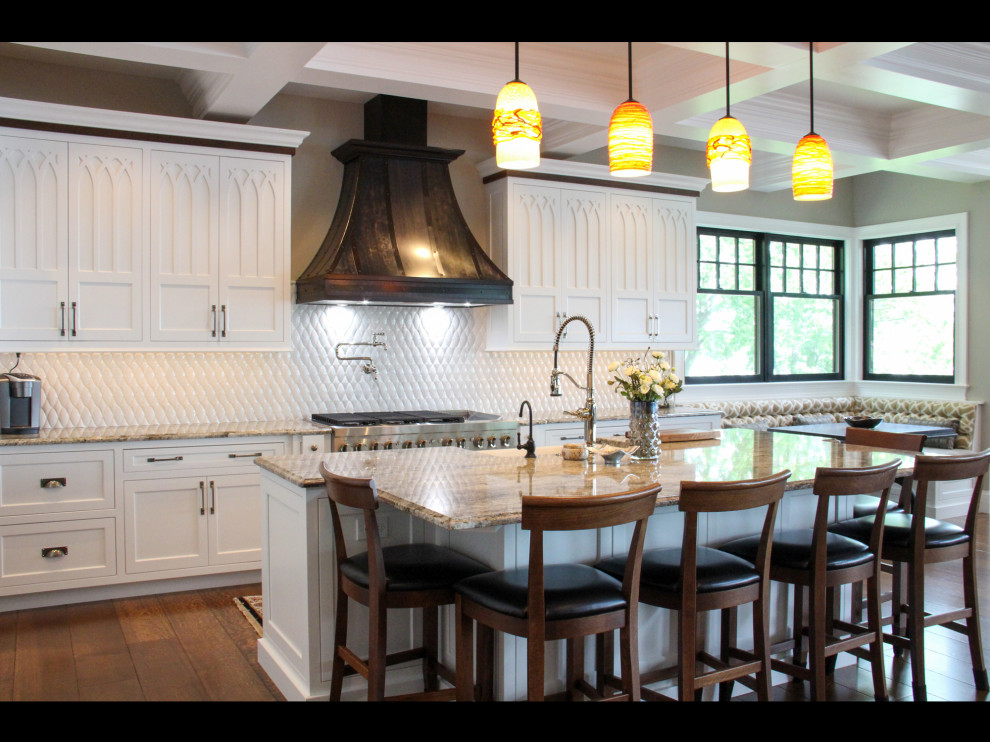 Large transitional l-shaped medium tone wood floor, brown floor and coffered ceiling open concept kitchen photo with a farmhouse sink, recessed-panel cabinets, white cabinets, granite countertops, white backsplash, stainless steel appliances, an island and beige countertops