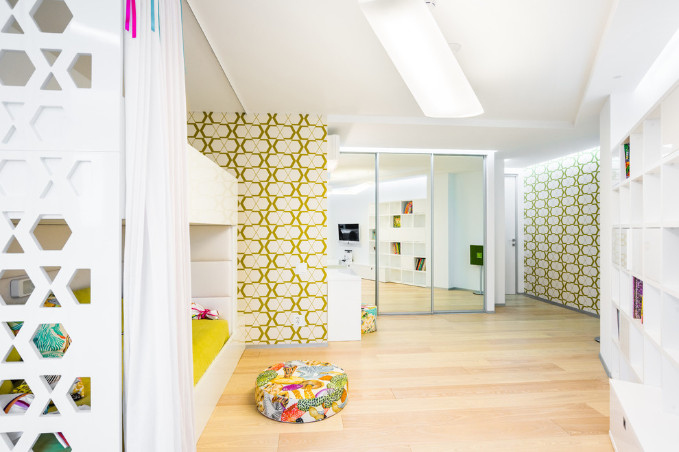 Design ideas for a scandinavian gender-neutral kids' room in Moscow with multi-coloured walls and light hardwood floors.