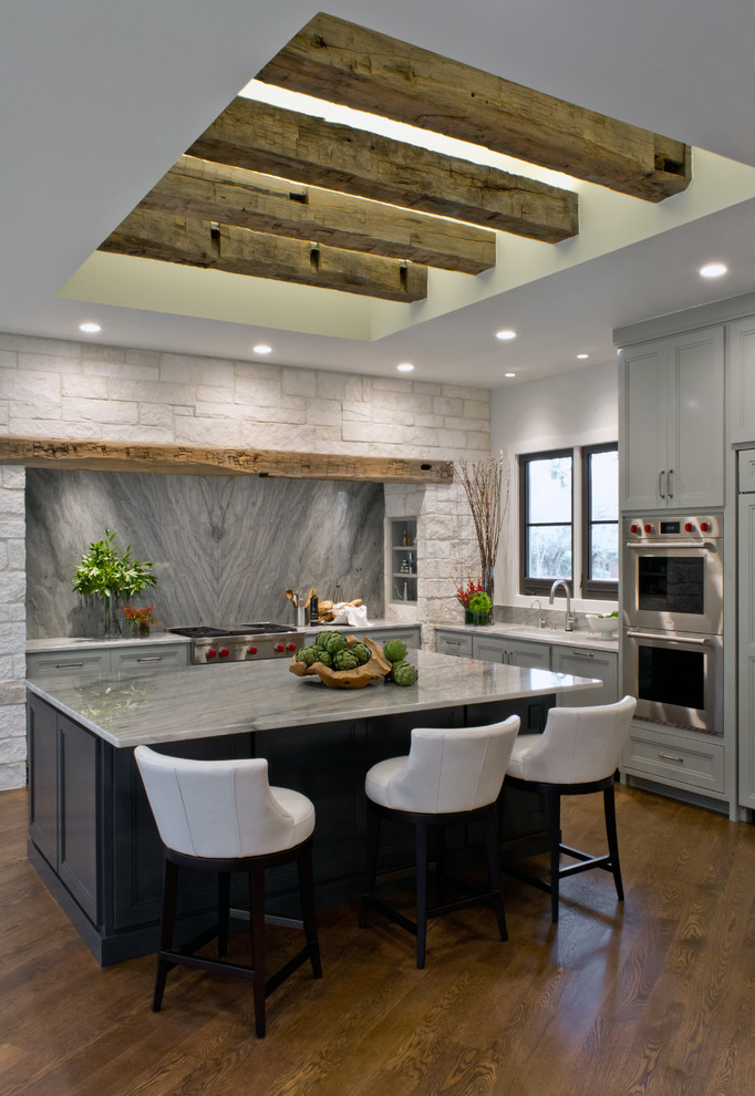 Example of a transitional l-shaped medium tone wood floor open concept kitchen design in Austin with an undermount sink, recessed-panel cabinets, green cabinets, quartzite countertops, green backsplash, stone slab backsplash, stainless steel appliances and an island