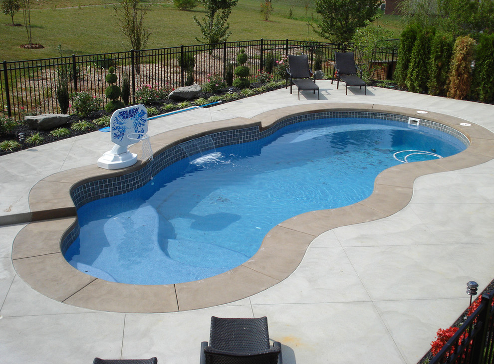 Inspiration for a large backyard concrete and custom-shaped natural pool remodel in Cincinnati