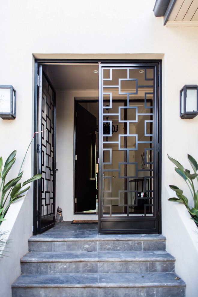 This is an example of a contemporary front door in Melbourne with a double front door and a metal front door.