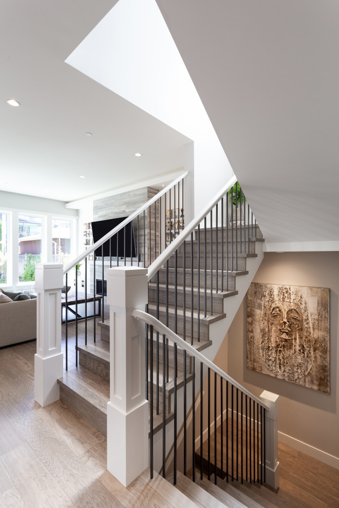 Photo of a mid-sized transitional wood u-shaped staircase in Vancouver with wood risers and mixed railing.
