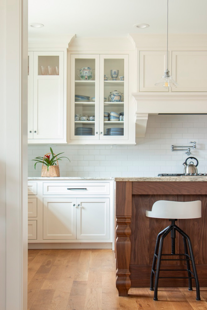 L-shaped open concept kitchen photo in Minneapolis with a farmhouse sink, flat-panel cabinets, white cabinets, white backsplash and an island