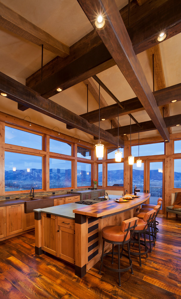 Inspiration for a large rustic medium tone wood floor eat-in kitchen remodel in Denver with a farmhouse sink, medium tone wood cabinets and an island