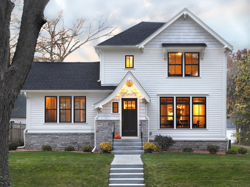 Photo of a mid-sized traditional two-storey white exterior in Minneapolis with wood siding.