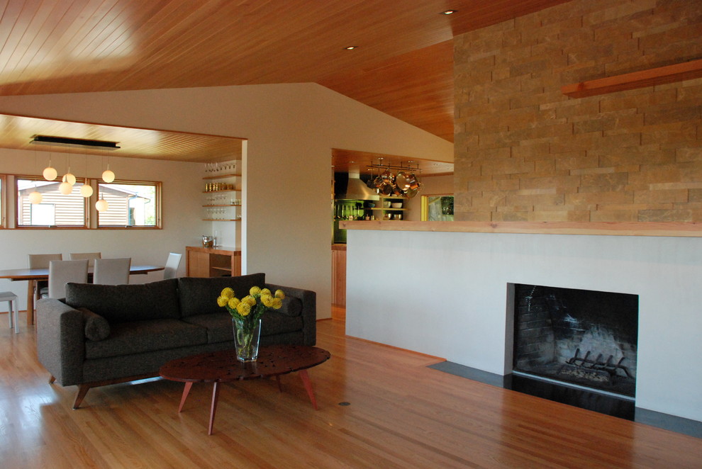 Inspiration for a midcentury open concept living room in Portland with white walls and light hardwood floors.