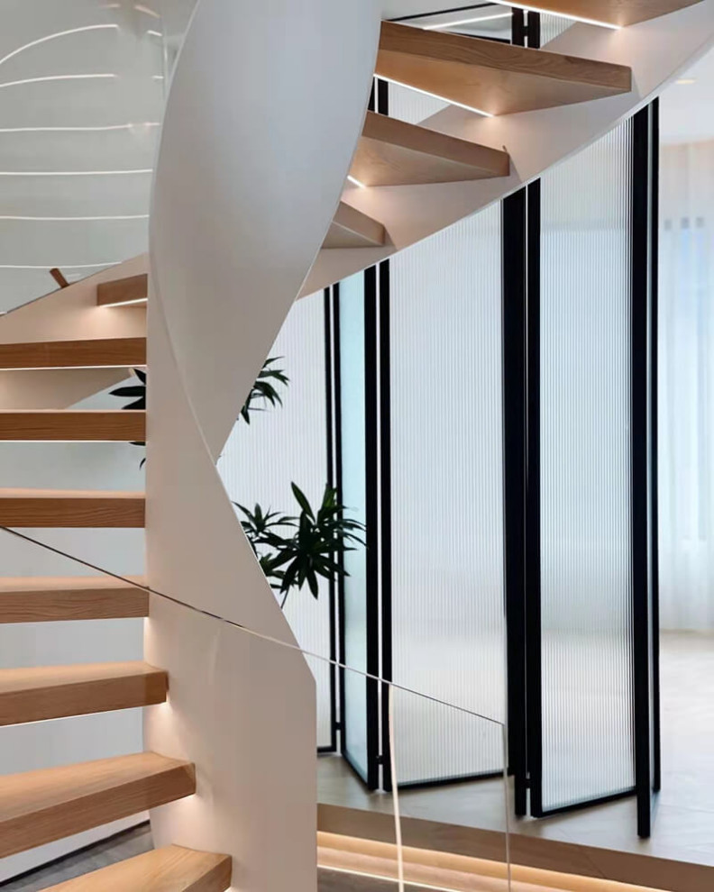 Photo of a medium sized modern wood curved glass railing staircase in Other with open risers and brick walls.