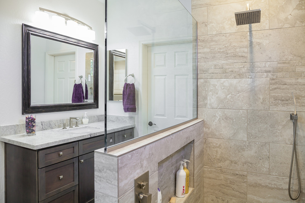 Example of a mid-sized transitional master beige tile and porcelain tile porcelain tile and brown floor alcove shower design in Phoenix with recessed-panel cabinets, dark wood cabinets, a one-piece toilet, orange walls, an undermount sink and granite countertops