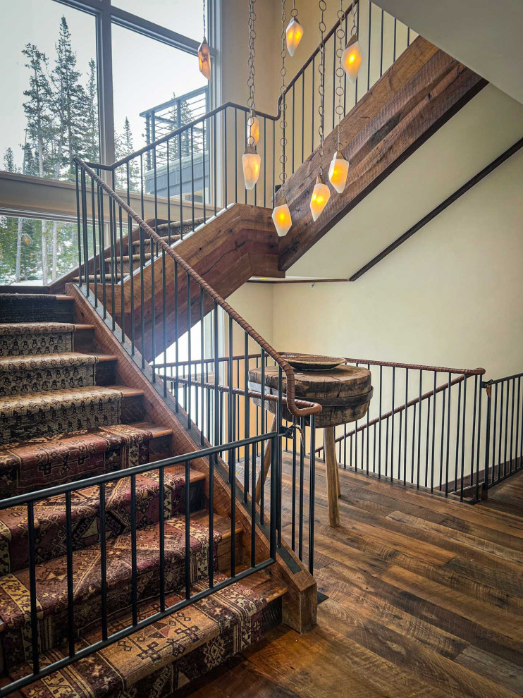 Country wood l-shaped staircase in Other with wood risers and metal railing.