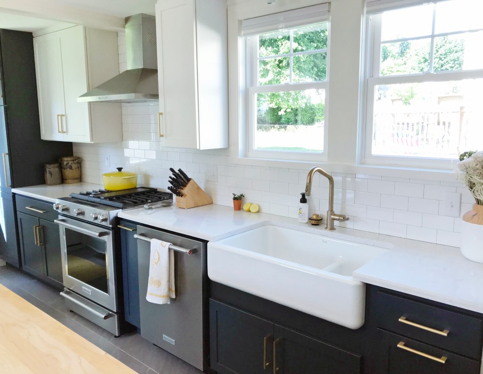 Transitional gray floor kitchen photo with a farmhouse sink, quartz countertops and stainless steel appliances