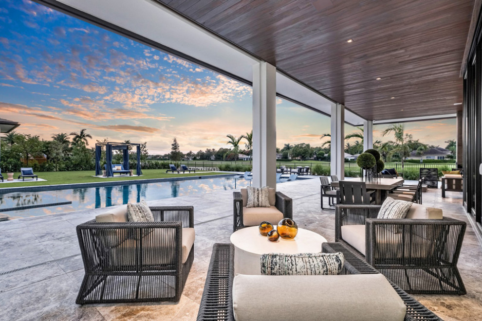This is an example of an expansive contemporary backyard patio in Miami.