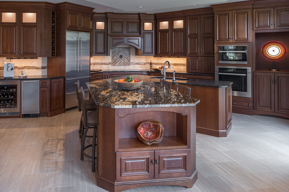 Large transitional kitchen photo with an undermount sink, raised-panel cabinets, stainless steel appliances and an island